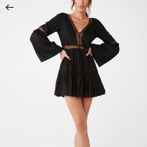 Bell sleeve, opened back, and fishnet mini dress